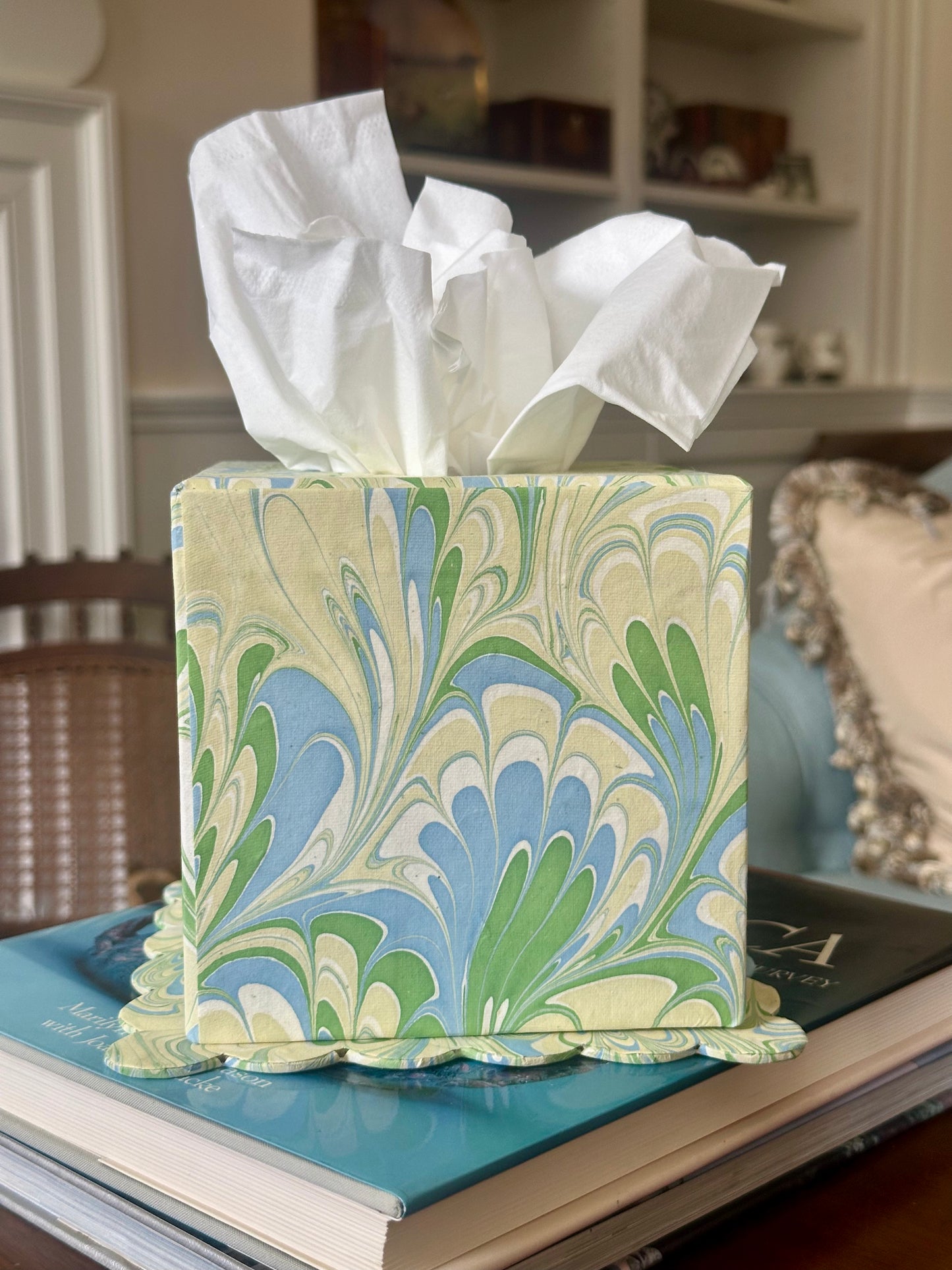 Marbled tissue box cover with tissues on a surface